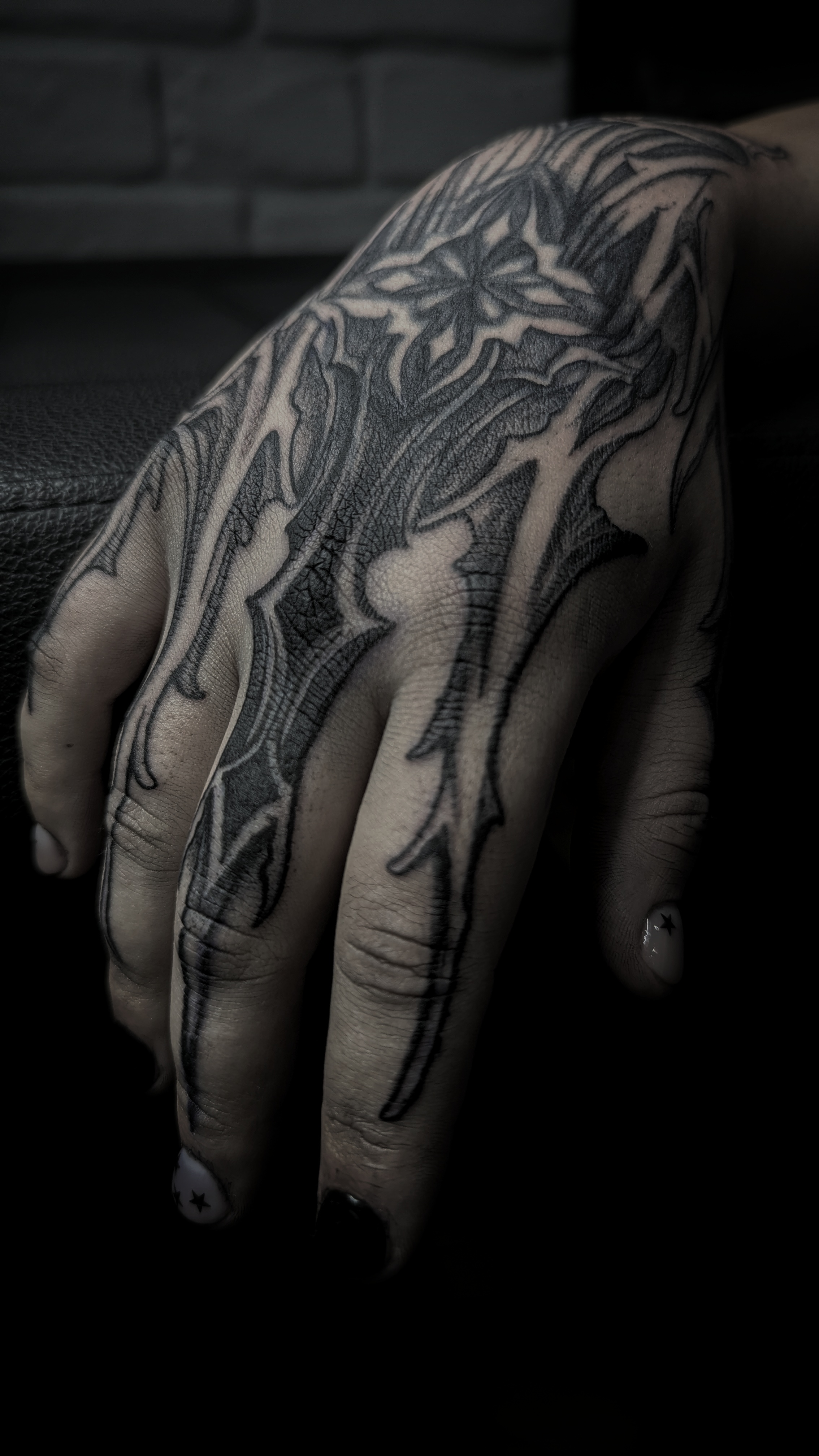 Dark ornament cover-up on the wrist